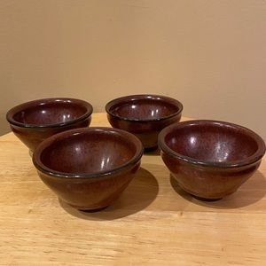 Set of four small dipping dishes for sushi.